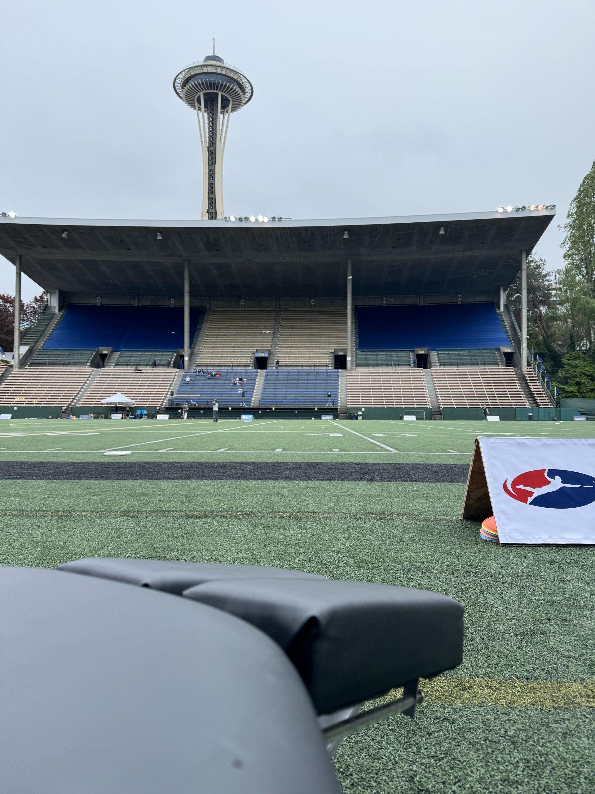 Dr. Cydney's table on the sideline at a semiprofessional ultimate frisbee game at Memorial Stadium in Seattle with the Space Needle in the background.