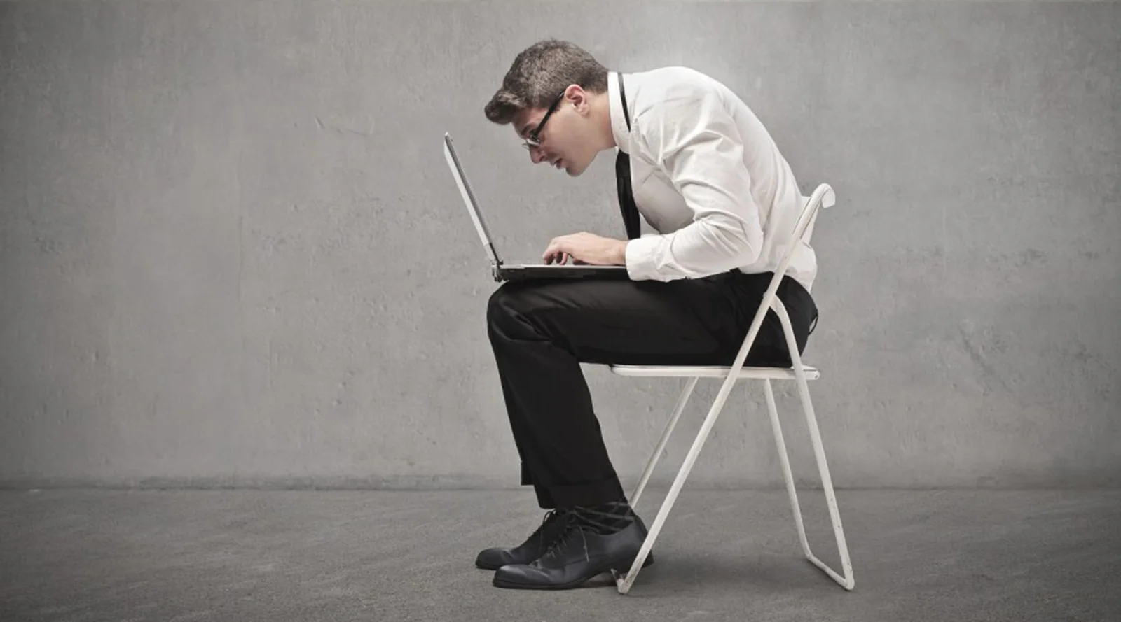 Hunched over laptop